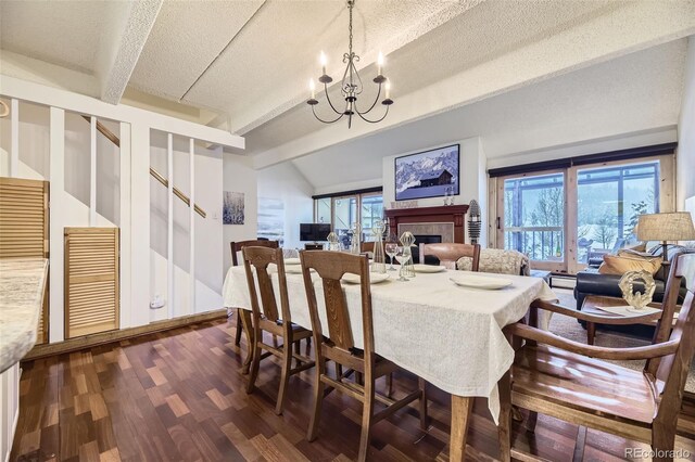 dining space with dark wood-type flooring, a wealth of natural light, a textured ceiling, and vaulted ceiling with beams