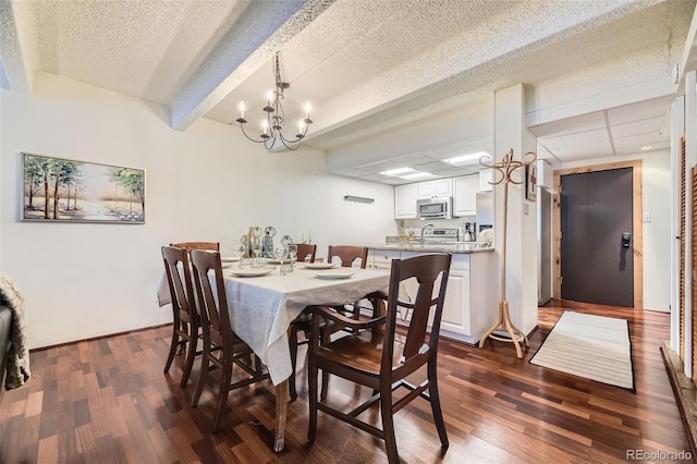 dining area featuring a textured ceiling, an inviting chandelier, and dark hardwood / wood-style flooring