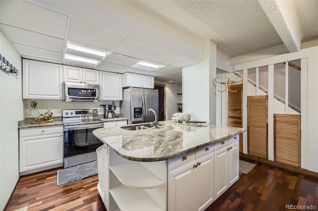 kitchen with stainless steel appliances, dark hardwood / wood-style floors, and white cabinetry