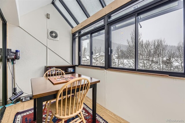 dining area featuring lofted ceiling and wood-type flooring