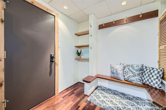 mudroom with dark hardwood / wood-style floors and a drop ceiling