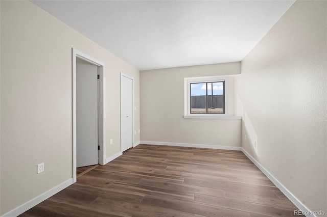 interior space featuring baseboards and wood finished floors