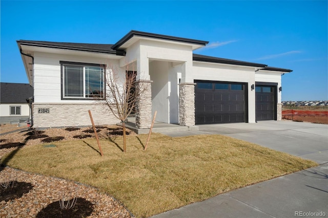 prairie-style house with a garage and a front yard