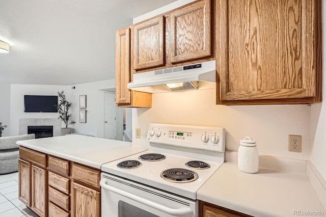 13093 W Cedar Dr Unit 121, Lakewood, CO 80228 - kitchen featuring white electric range, under cabinet range hood, open floor plan, a tiled fireplace, and light countertops