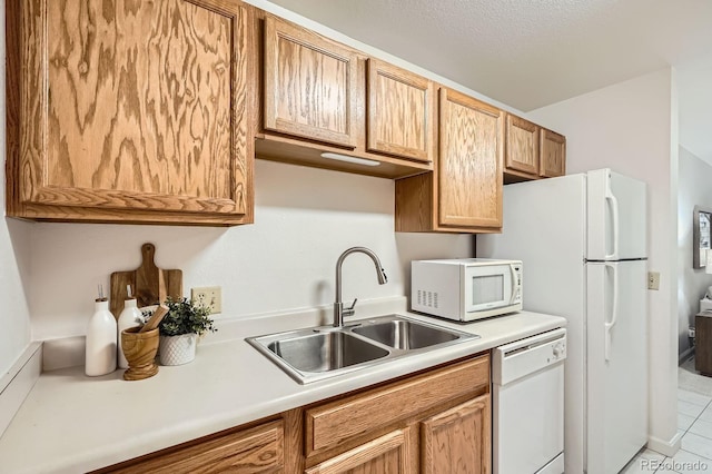 13093 W Cedar Dr Unit 121, Lakewood, CO 80228 - kitchen with white appliances, light countertops, and light tile patterned flooring