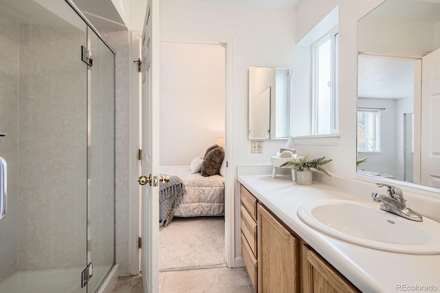 13093 W Cedar Dr Unit 121, Lakewood, CO 80228 - ensuite bathroom featuring vanity, a stall shower, and tile patterned flooring