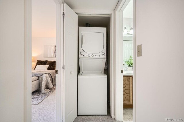 13093 W Cedar Dr Unit 121, Lakewood, CO 80228 - laundry area with stacked washer / drying machine and light carpet