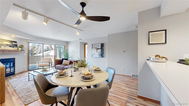 dining room featuring light hardwood / wood-style flooring and ceiling fan