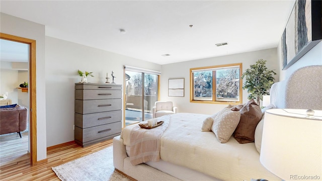 bedroom featuring light hardwood / wood-style flooring and access to outside