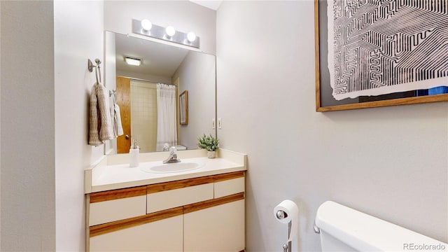 bathroom featuring vanity and toilet