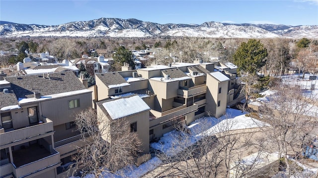 snowy aerial view featuring a mountain view