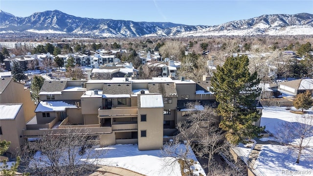 snowy aerial view featuring a mountain view