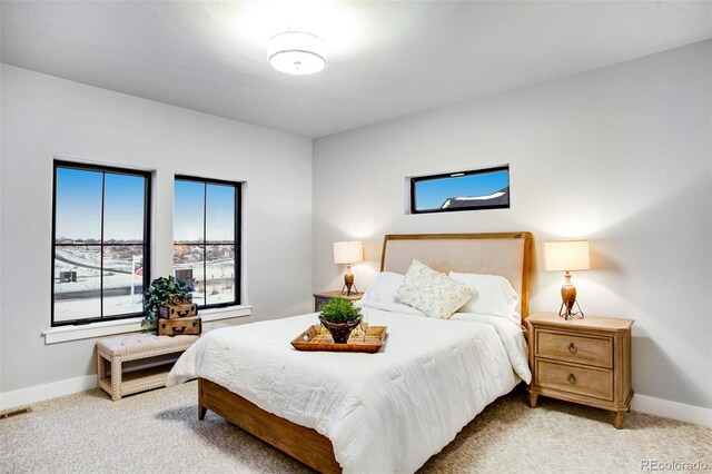 bedroom featuring light colored carpet