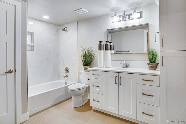 full bathroom featuring tile patterned flooring, toilet, tiled shower / bath combo, and vanity