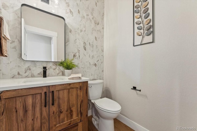1361 Art Dr, Berthoud, CO 80513 - bathroom featuring vanity, baseboards, toilet, and wood finished floors