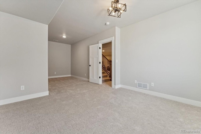 1361 Art Dr, Berthoud, CO 80513 - unfurnished room featuring light colored carpet, stairway, baseboards, a smoke detector, and a chandelier
