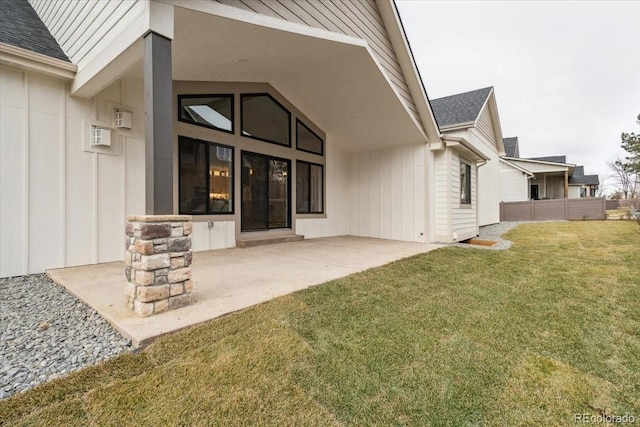 1361 Art Dr, Berthoud, CO 80513 - back of property with a shingled roof, a yard, a patio area, and board and batten siding
