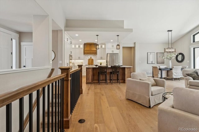 1361 Art Dr, Berthoud, CO 80513 - living room featuring light wood-type flooring, a chandelier, and recessed lighting