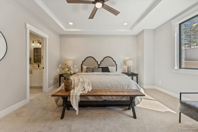 1361 Art Dr, Berthoud, CO 80513 - bedroom featuring light carpet, connected bathroom, recessed lighting, a tray ceiling, and baseboards