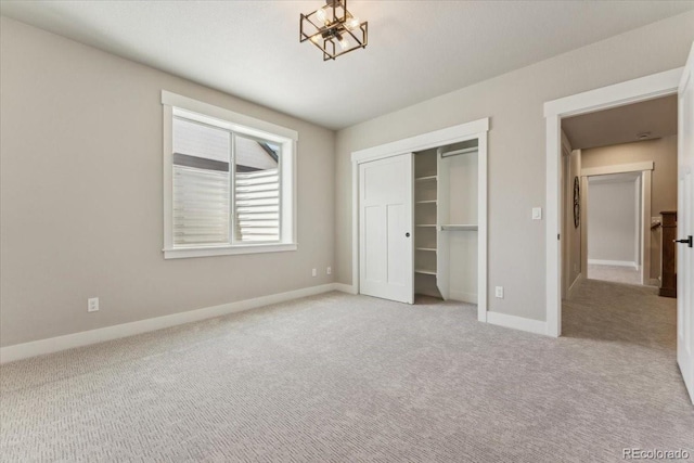 1361 Art Dr, Berthoud, CO 80513 - unfurnished bedroom with light colored carpet, baseboards, a closet, and a chandelier