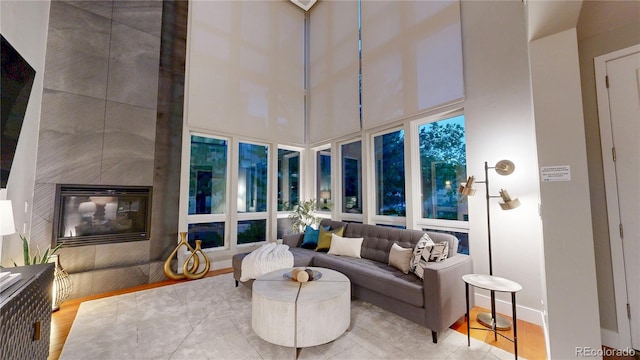 8041 E 29th Ave, Denver, CO 80238 - living room with a high ceiling, wood finished floors, and a fireplace