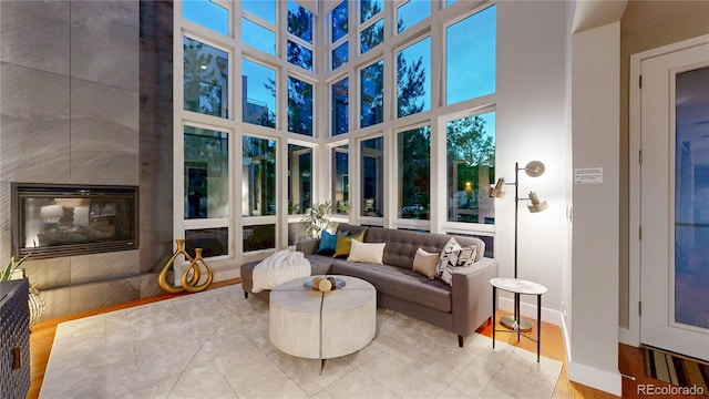 8041 E 29th Ave, Denver, CO 80238 - living area with a high ceiling, tile patterned flooring, and a tile fireplace