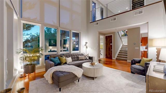 8041 E 29th Ave, Denver, CO 80238 - living area featuring light wood-style flooring, stairway, and a high ceiling