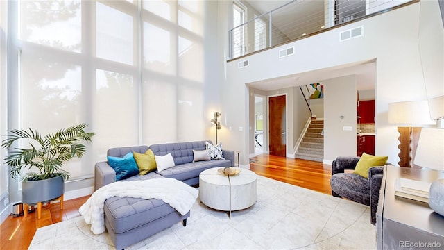 8041 E 29th Ave, Denver, CO 80238 - living room with stairs, a high ceiling, and wood finished floors