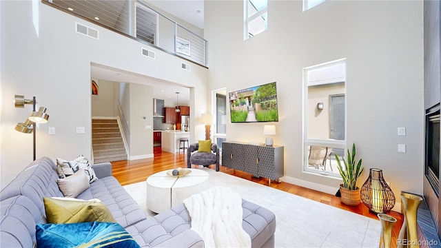8041 E 29th Ave, Denver, CO 80238 - living area with stairs, wood finished floors, and a high ceiling