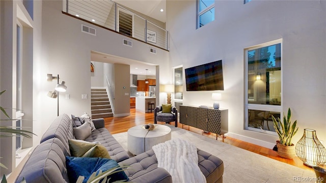 8041 E 29th Ave, Denver, CO 80238 - living area with wood finished floors, stairs, and a high ceiling