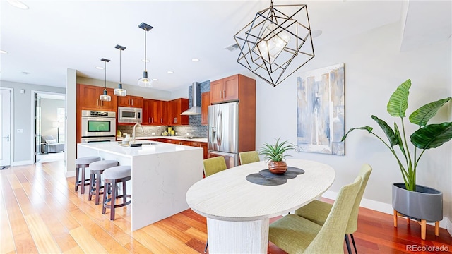 8041 E 29th Ave, Denver, CO 80238 - dining space with light wood finished floors, recessed lighting, and a chandelier
