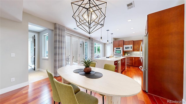 8041 E 29th Ave, Denver, CO 80238 - dining area with a chandelier, light wood finished floors, and recessed lighting