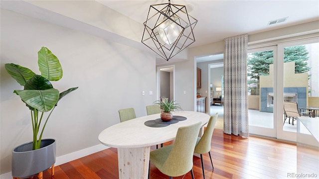 8041 E 29th Ave, Denver, CO 80238 - dining area featuring a chandelier and light wood-type flooring