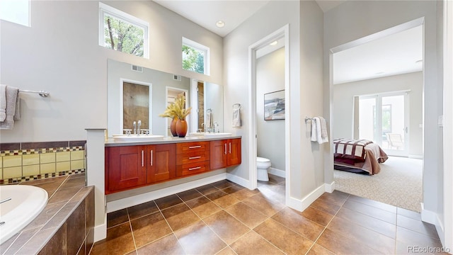 8041 E 29th Ave, Denver, CO 80238 - full bathroom with double vanity, plenty of natural light, a garden tub, tile patterned flooring, and a high ceiling