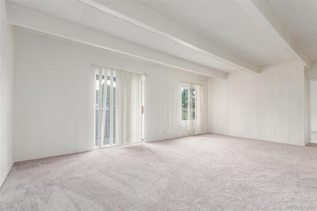 9725 E Harvard Ave Unit 317, Denver, CO 80231 - empty room featuring beamed ceiling, carpet, and a textured ceiling
