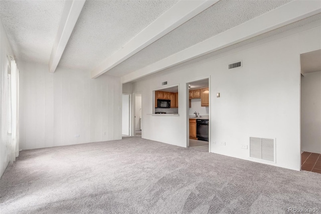 9725 E Harvard Ave Unit 317, Denver, CO 80231 - unfurnished living room with beamed ceiling, light carpet, a textured ceiling, and a sink
