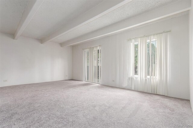 9725 E Harvard Ave Unit 317, Denver, CO 80231 - spare room featuring beam ceiling, carpet floors, and a textured ceiling