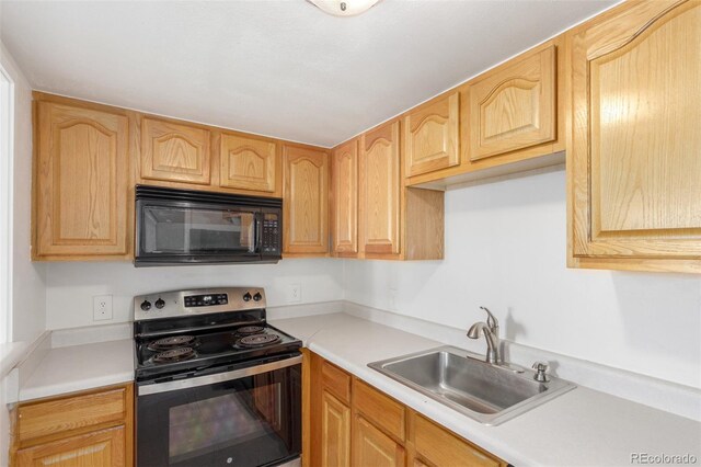 9725 E Harvard Ave Unit 317, Denver, CO 80231 - kitchen featuring black microwave, stainless steel electric range, a sink, light countertops, and light brown cabinets