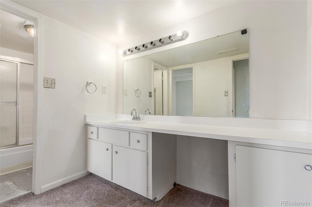 9725 E Harvard Ave Unit 317, Denver, CO 80231 - bathroom with vanity, baseboards, enclosed tub / shower combo, and carpet floors