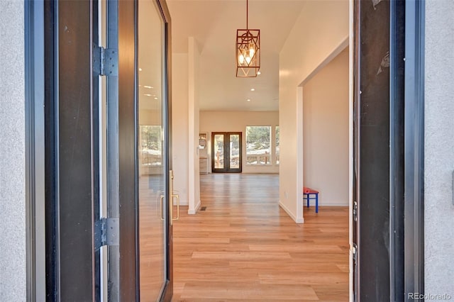 foyer entrance featuring baseboards and light wood finished floors