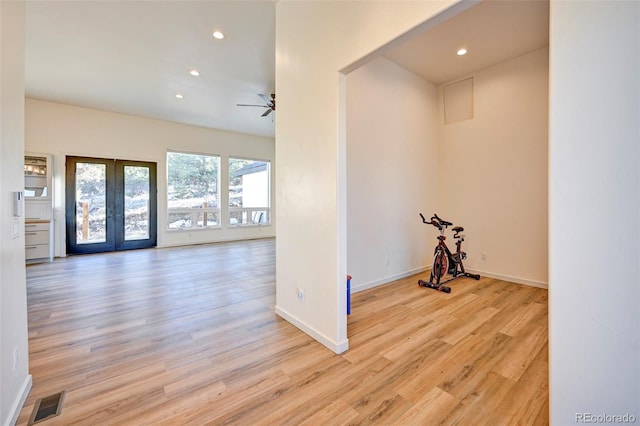 interior space with baseboards, visible vents, wood finished floors, french doors, and recessed lighting