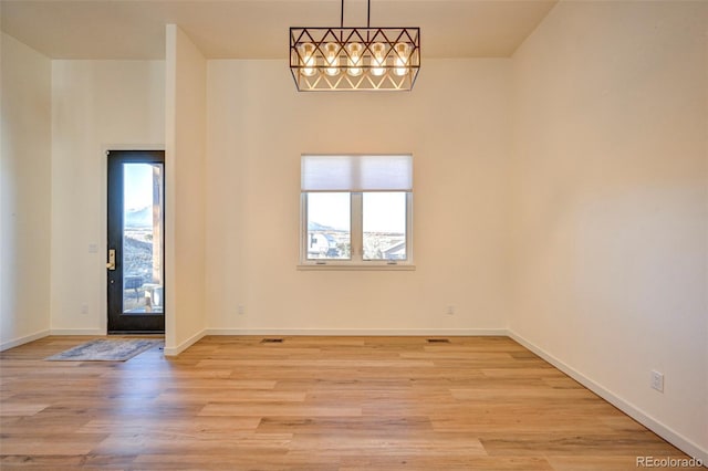 foyer entrance with light wood-type flooring and baseboards