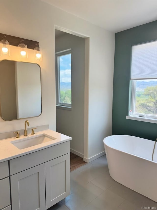 10373 Hutchinson Ln, Poncha Springs, CO 81242 - full bath featuring a freestanding bath, vanity, and tile patterned floors