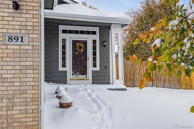 view of snow covered property entrance