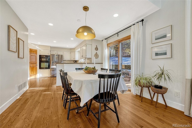 dining space featuring light hardwood / wood-style floors