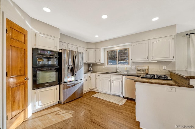 kitchen featuring white cabinetry, light hardwood / wood-style flooring, stainless steel appliances, and sink