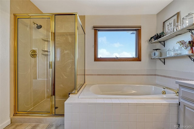 bathroom with vanity and independent shower and bath