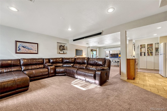 carpeted living room with a textured ceiling