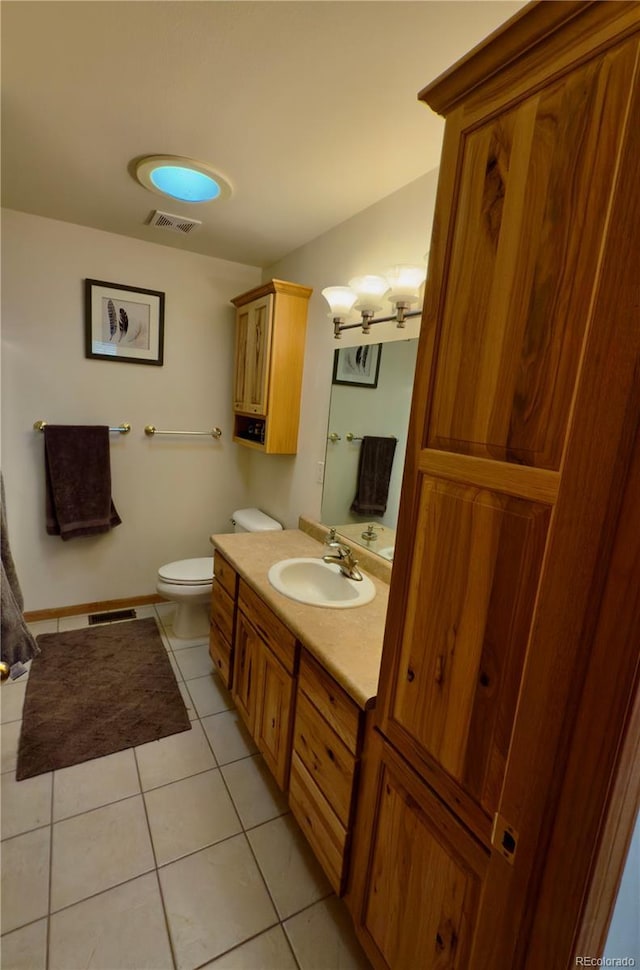 1436 H St Unit B, Salida, CO 81201 - bathroom featuring vanity, tile patterned flooring, toilet, a chandelier, and baseboards