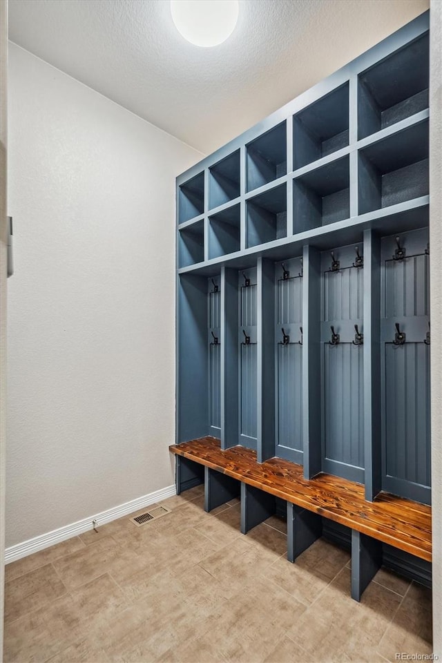 mudroom featuring a textured ceiling